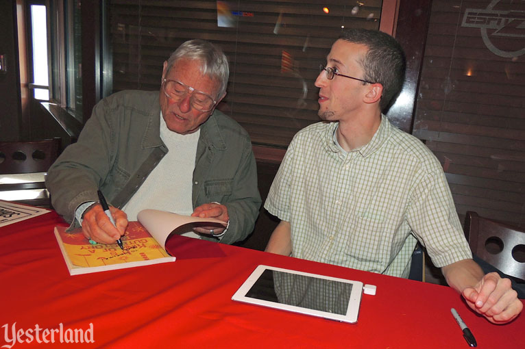 Rolly Crump signing copies of It’s Kind of a Cute Story